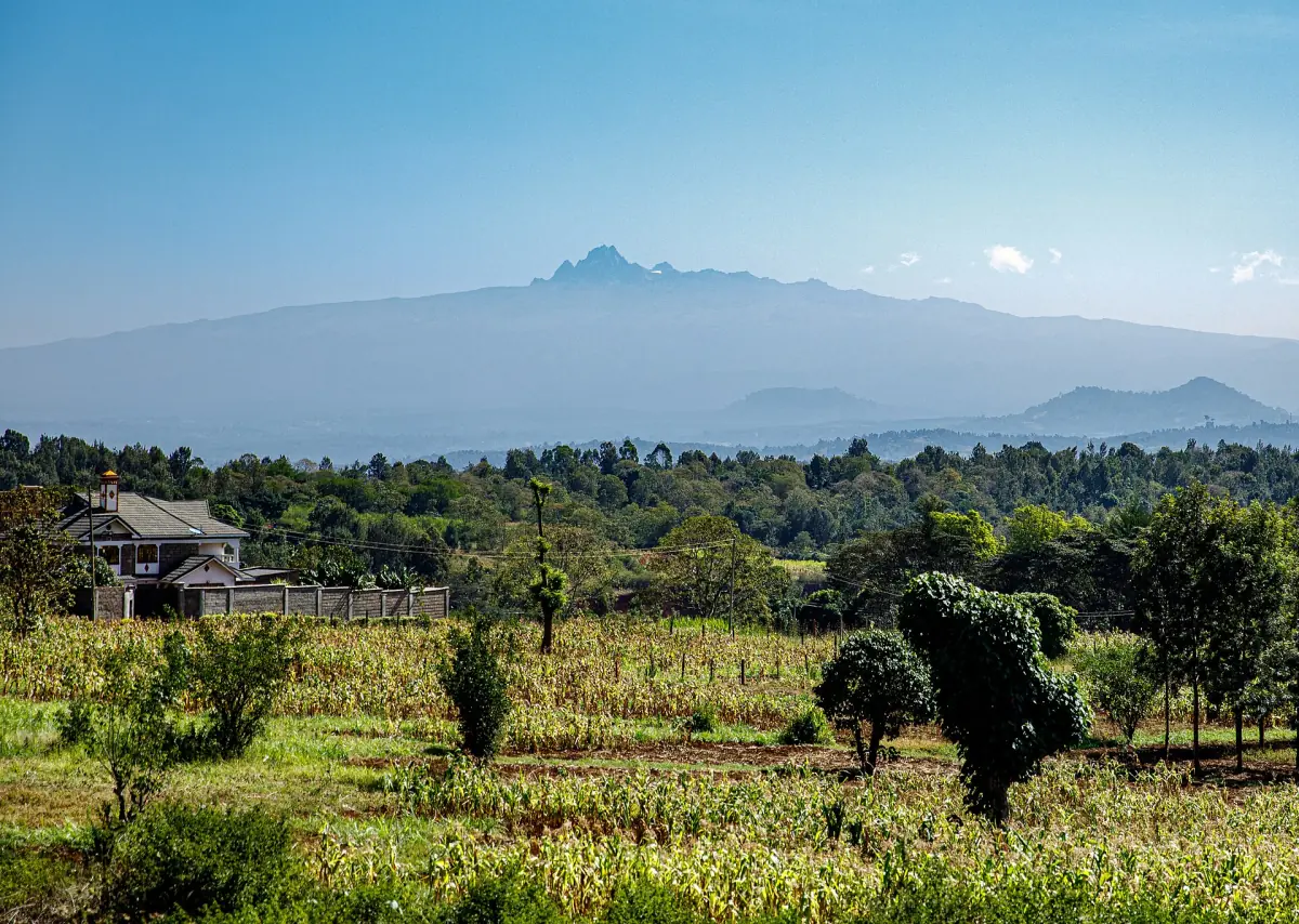 Hazy view over Nyeri farmland to the jagged peaks of Mount Kenya